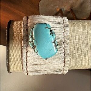 Leather wrist cuff.